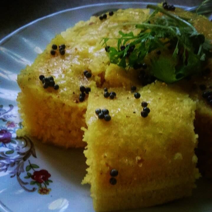Slices of homemade Gujarati Handvo garnished with coriander, flat-lay style