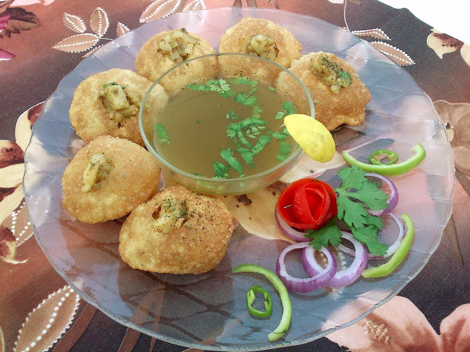 Plate of homemade Pani Puri with tamarind and mint water